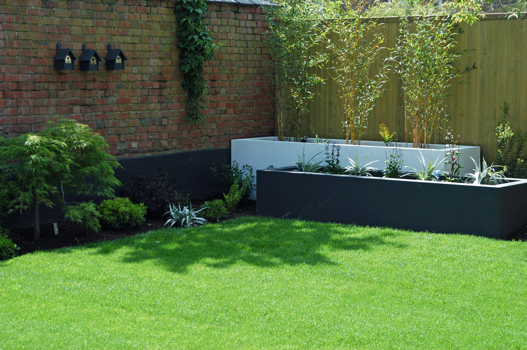 Rendered raised beds painted dark grey and white
